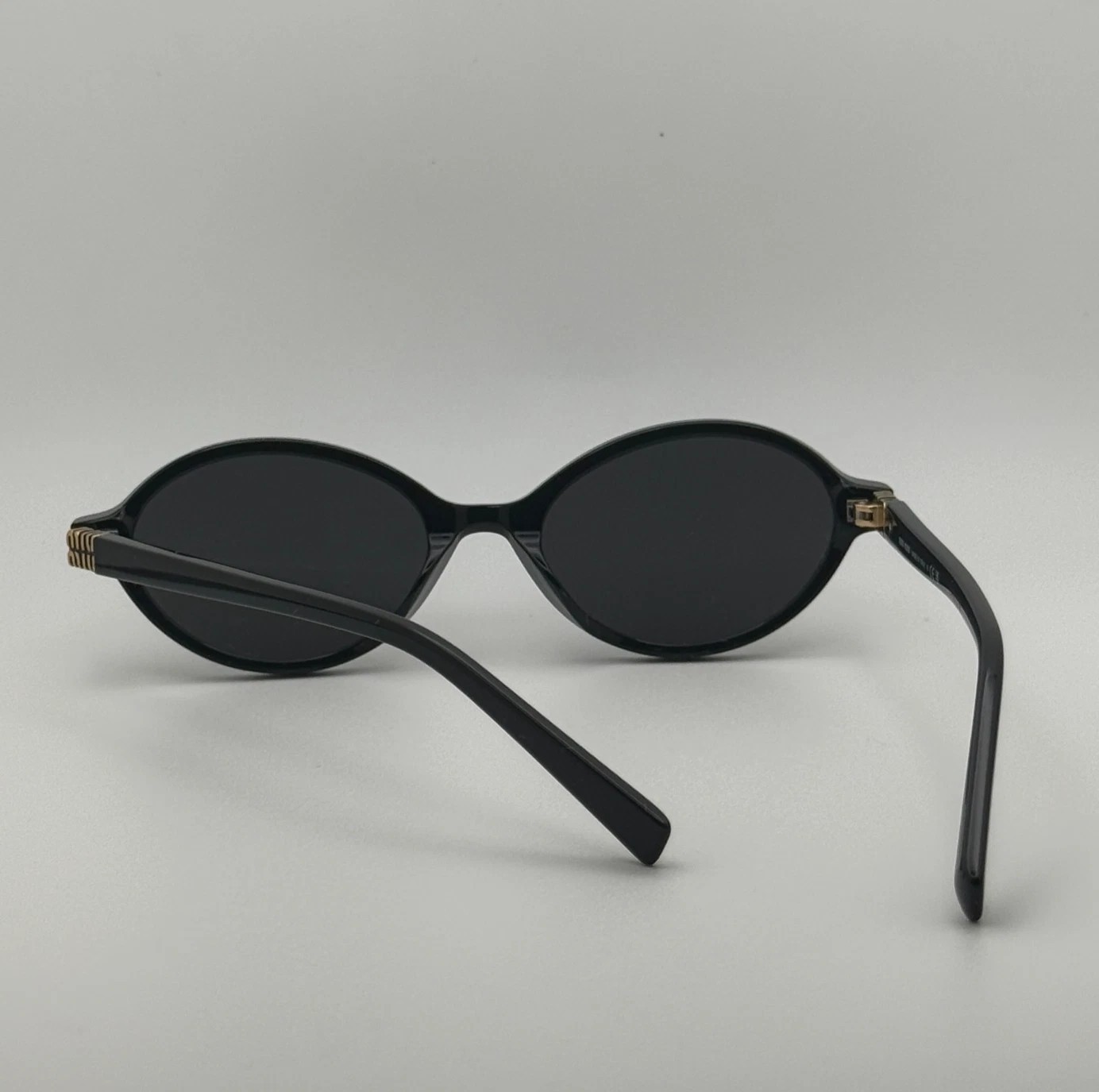 Miu Miu MU04ZS Round Oval Women’s Sunglasses Black Frame Dark Lenses