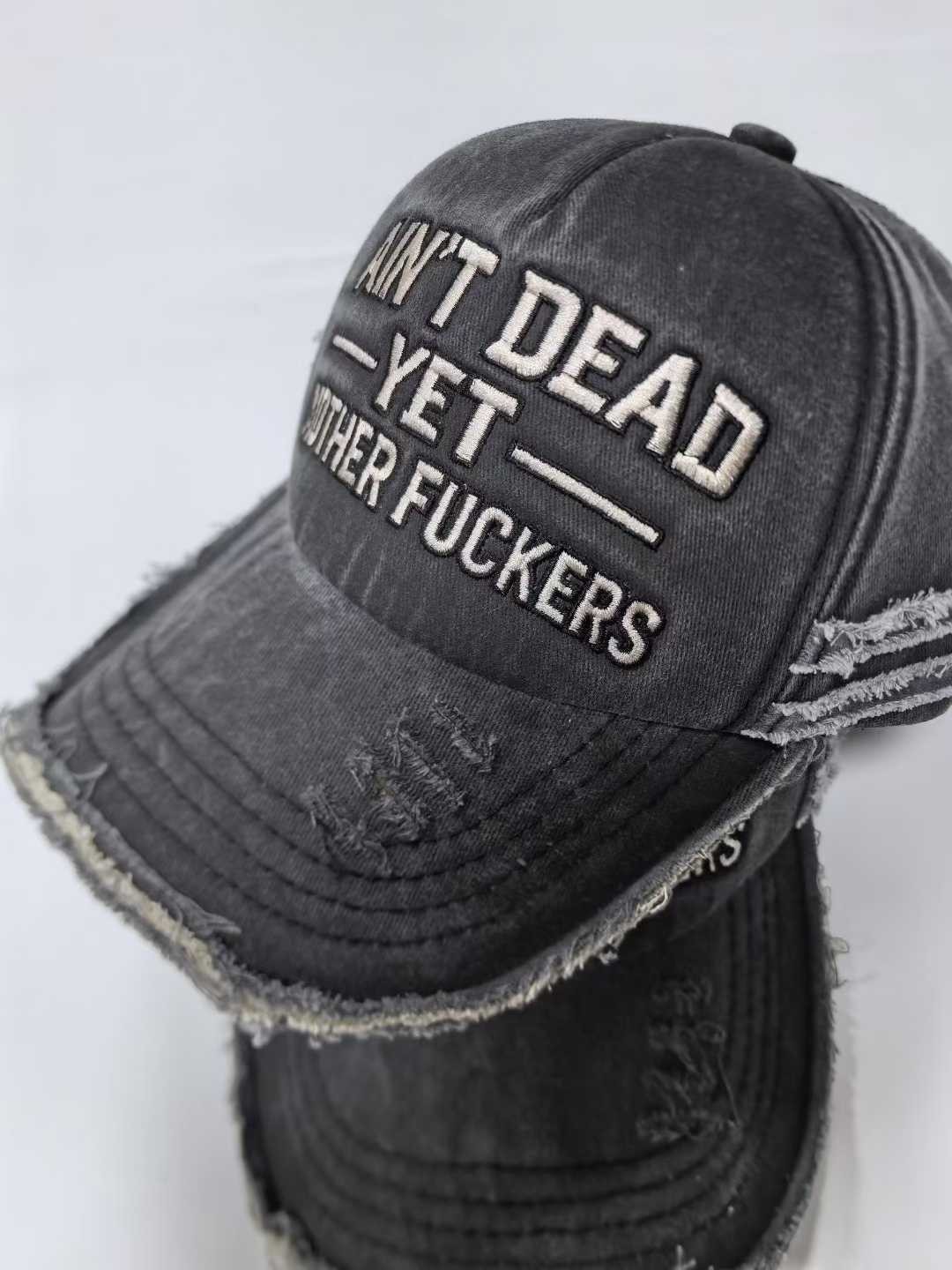 “Ain’t Dead Yet” Distressed Washed Black Baseball Cap | Embroidered Dad Hat