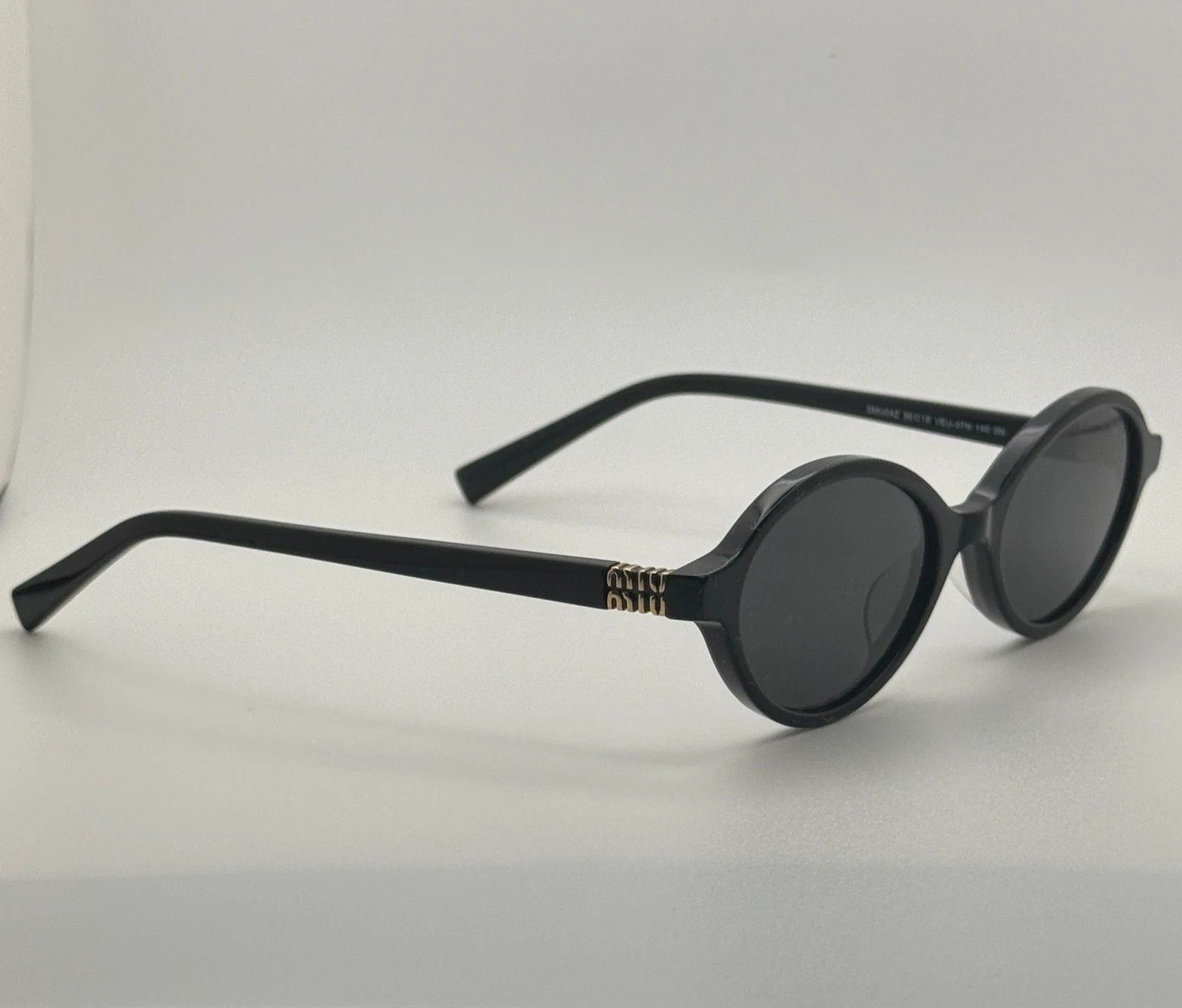 Miu Miu MU04ZS Round Oval Women’s Sunglasses Black Frame Dark Lenses