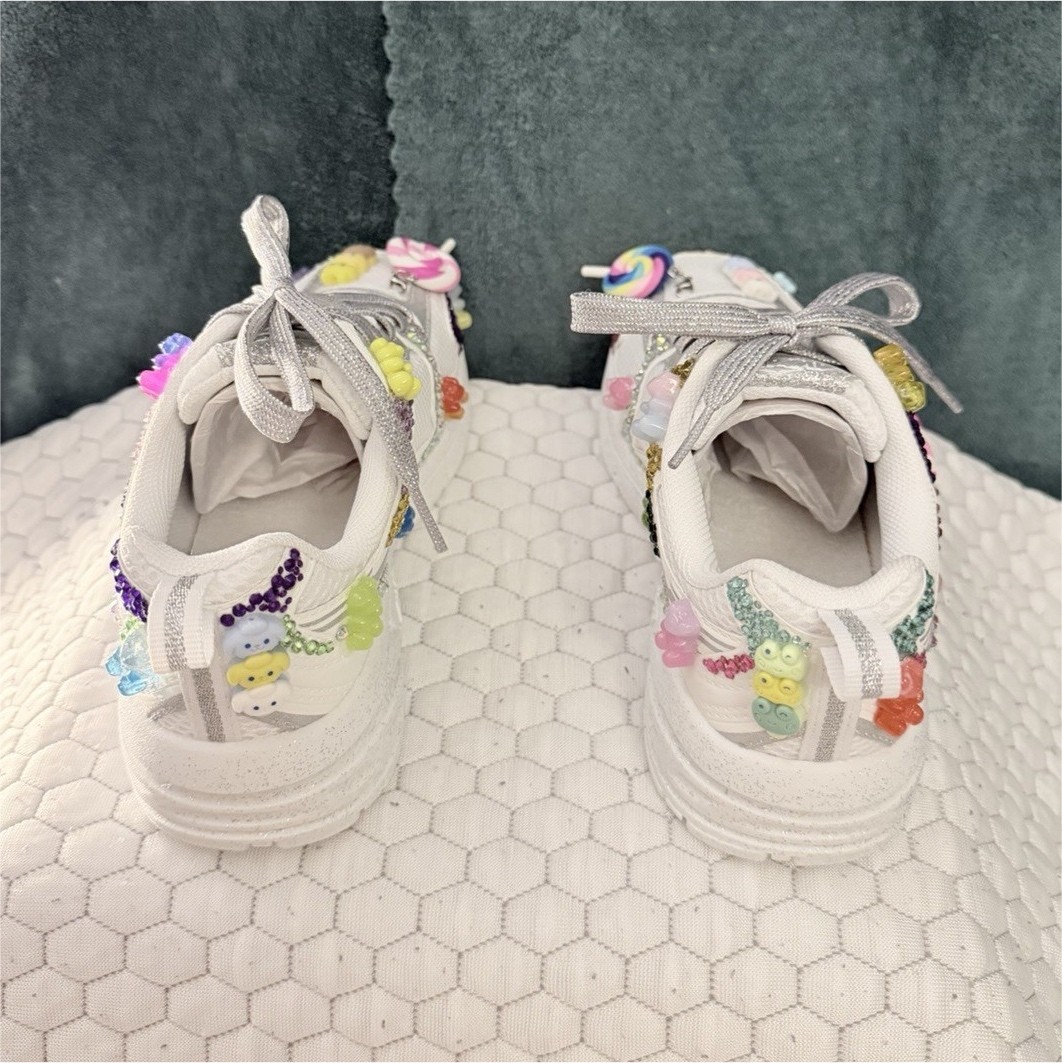 Hand-customized white Avia sneakers with silver laces. Shoe size is 1.
