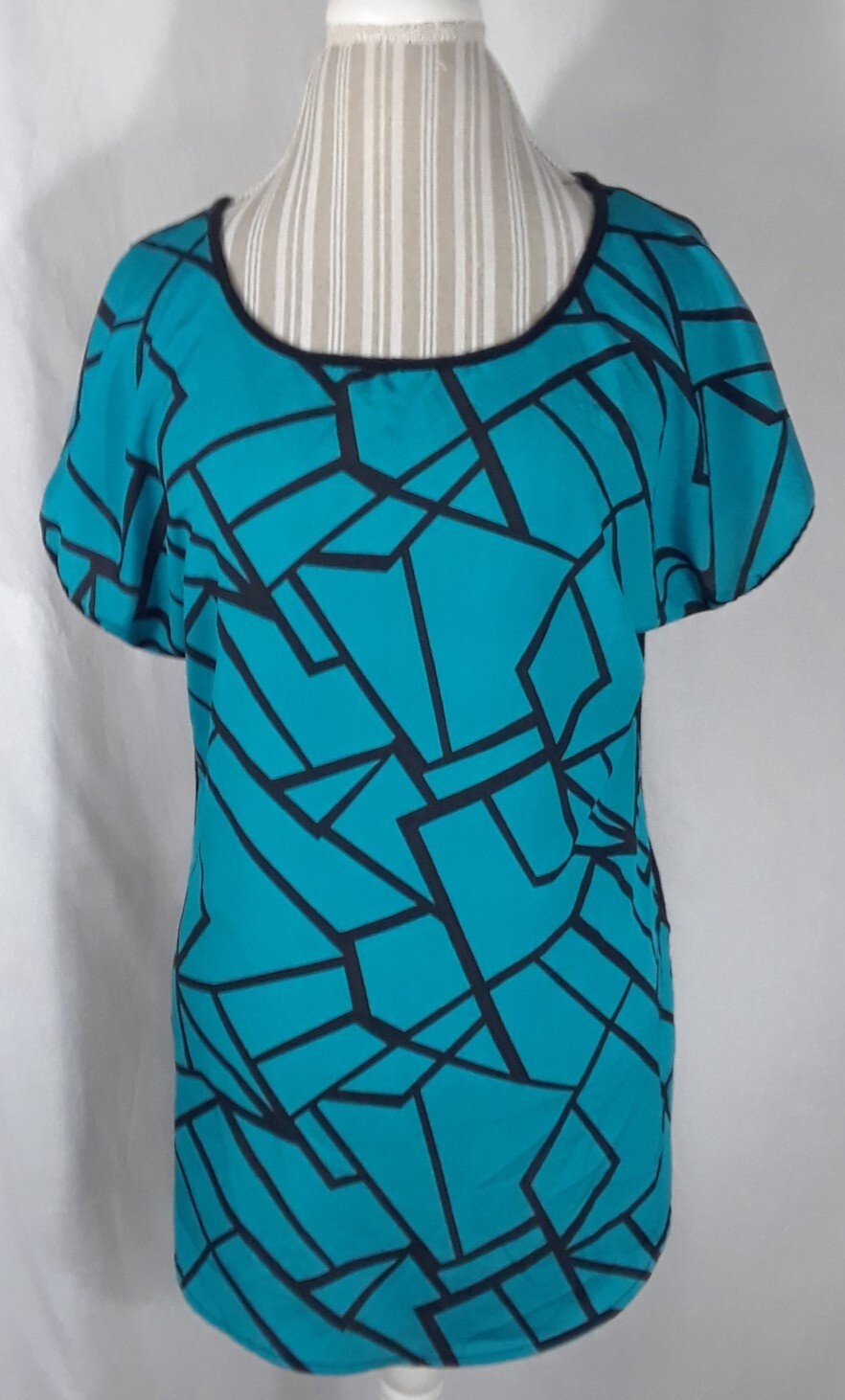 TA1-22 Espresso Women’s XL Blouse in black with blue geometric patterns in front