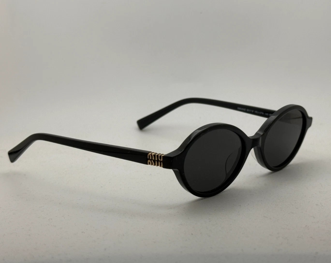 Miu Miu MU04ZS Round Oval Women’s Sunglasses Black Frame Dark Lenses