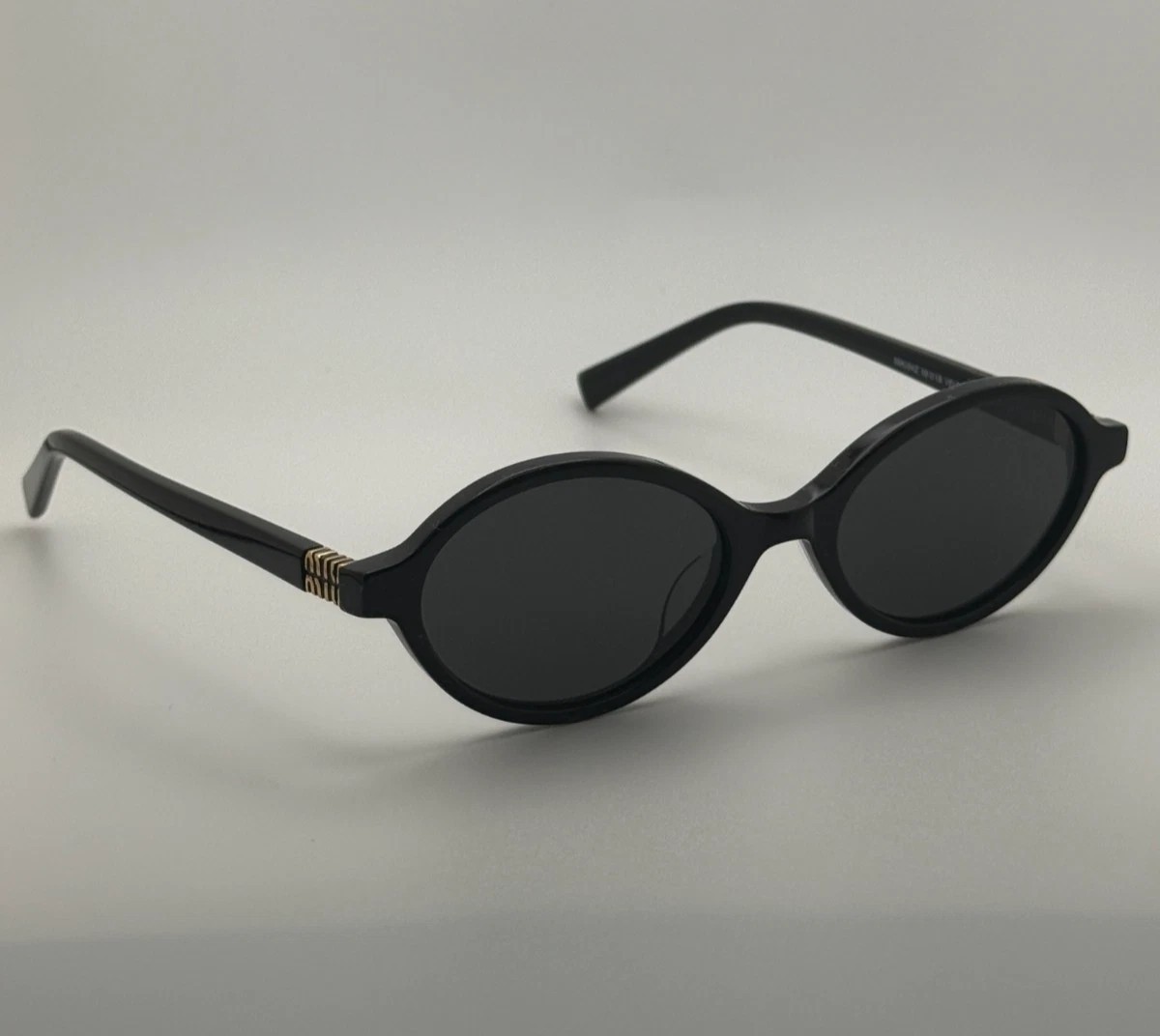 Miu Miu MU04ZS Round Oval Women’s Sunglasses Black Frame Dark Lenses