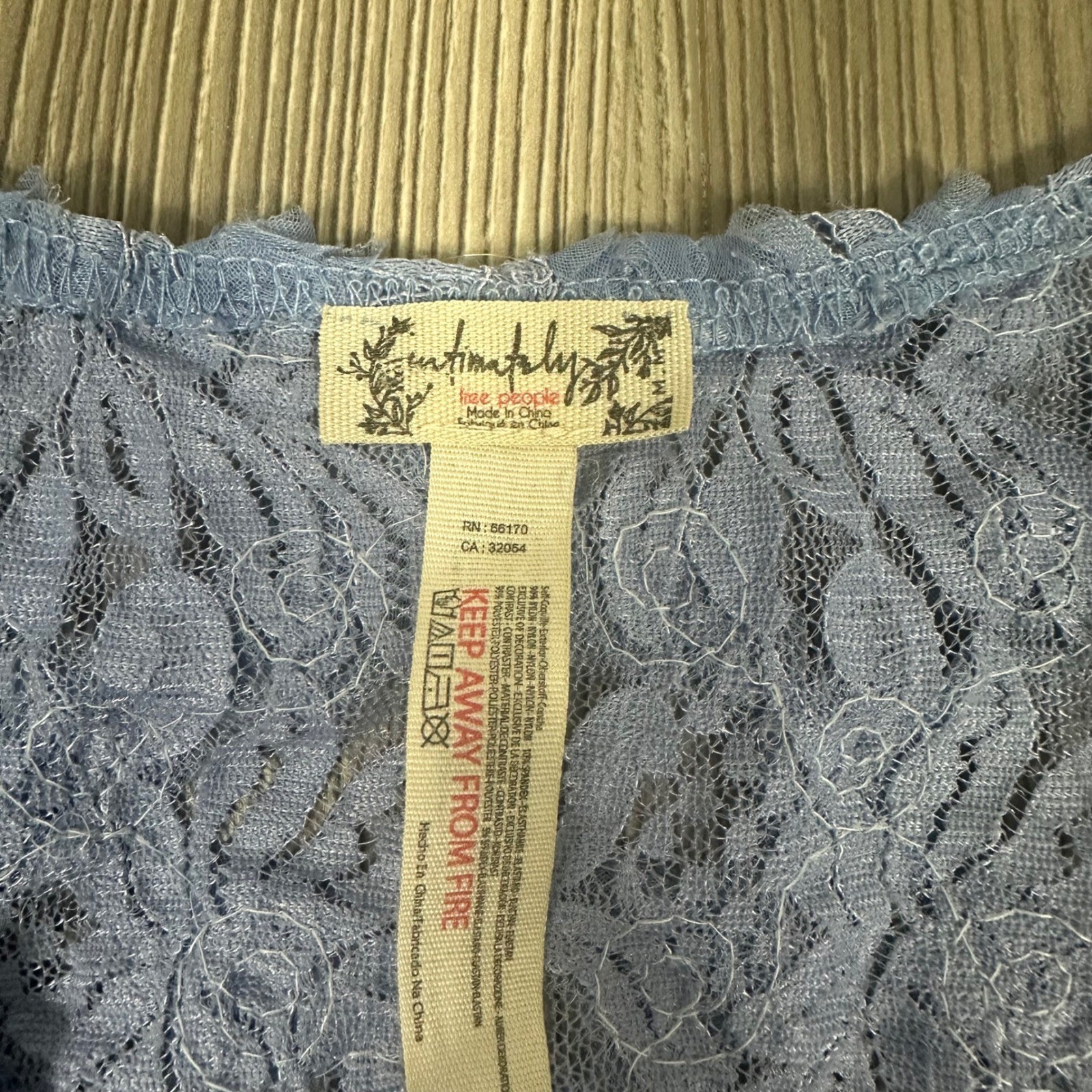 Free People Periwinkle Sheer Low Cut Floral Bodysuit w/ Rosette Details – SIZE M