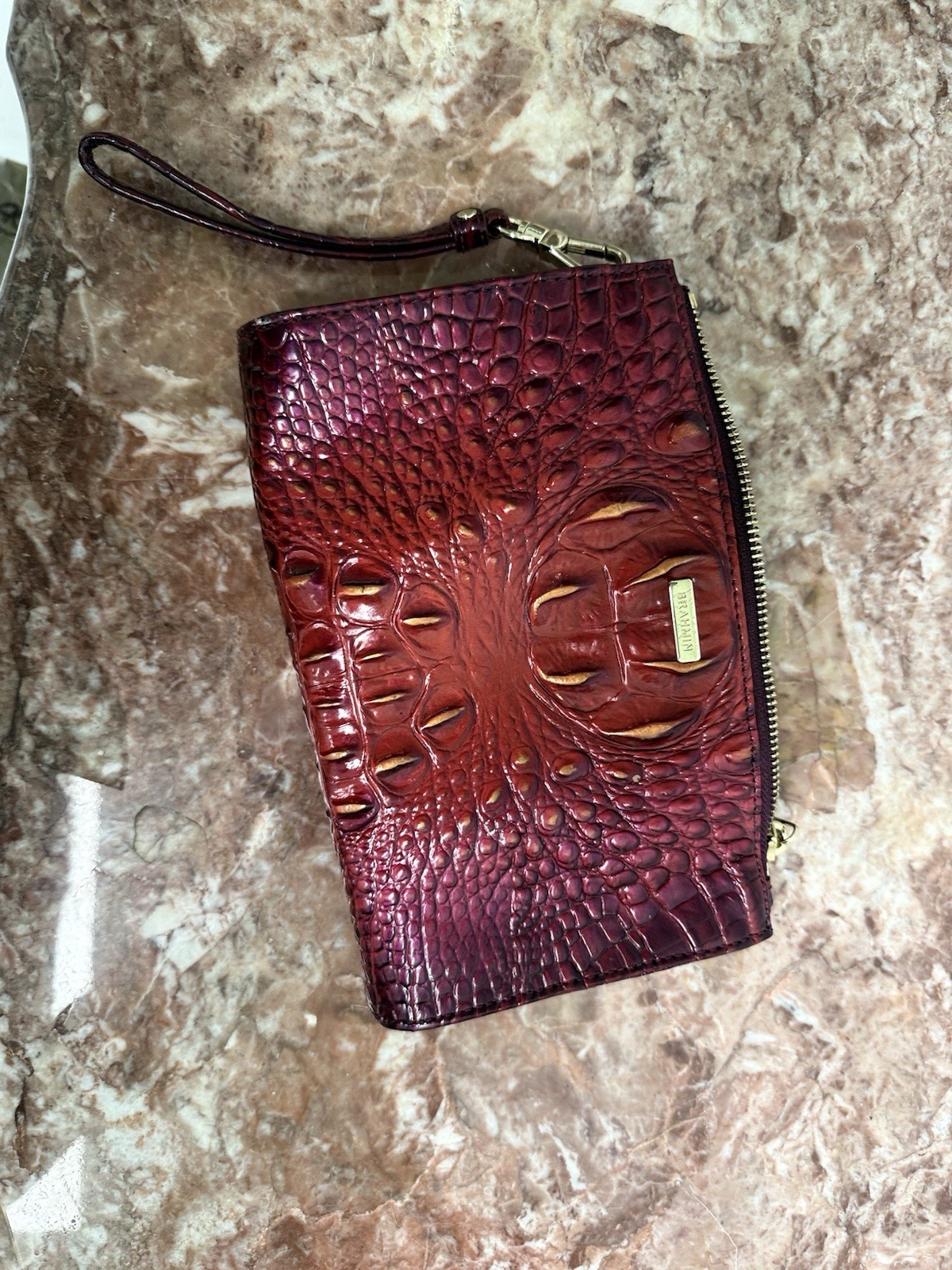 Brahmin Melbourne Daisy wristlet in an red and purple ombre crocodile leather