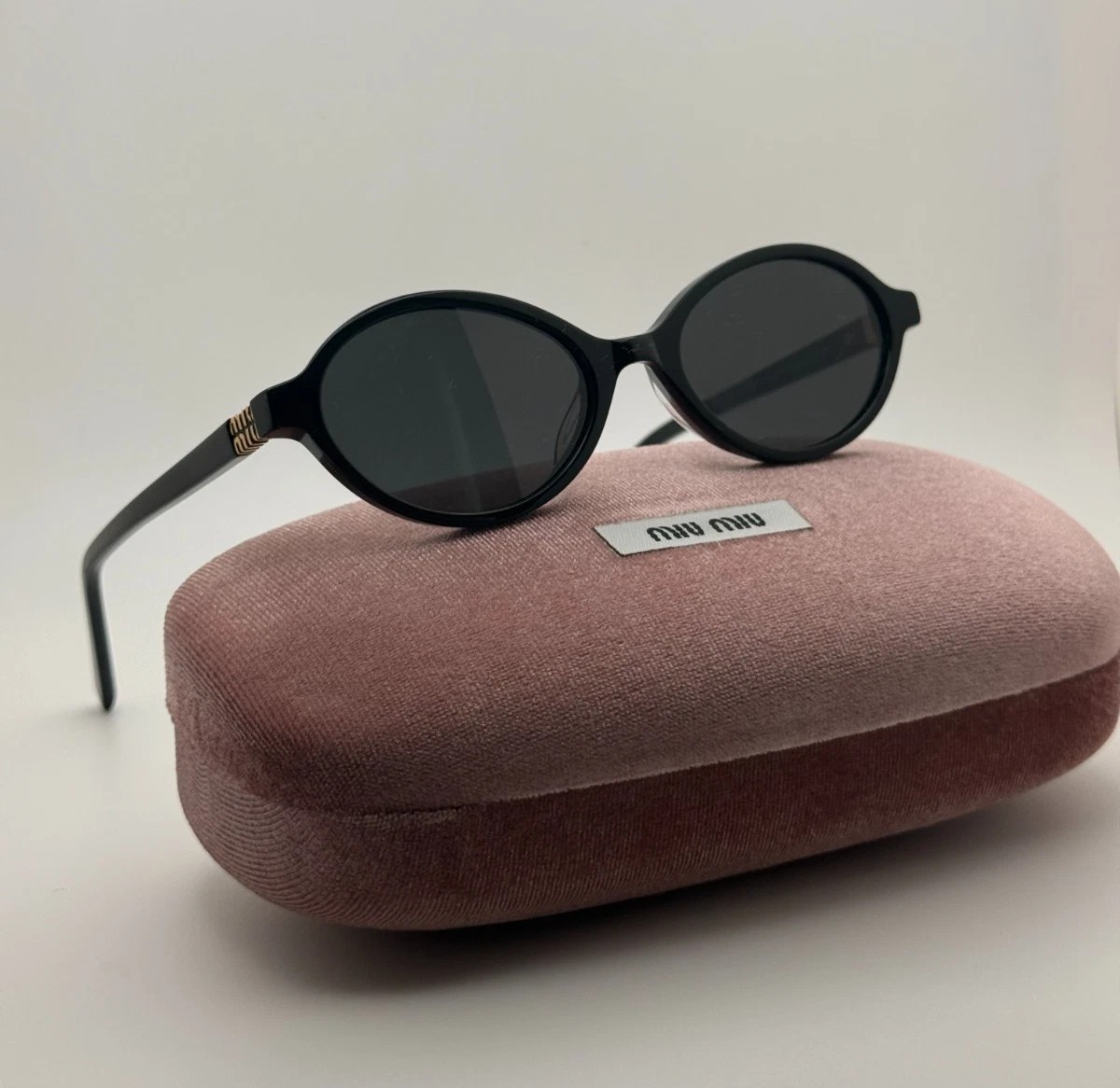 Miu Miu MU04ZS Round Oval Women’s Sunglasses Black Frame Dark Lenses