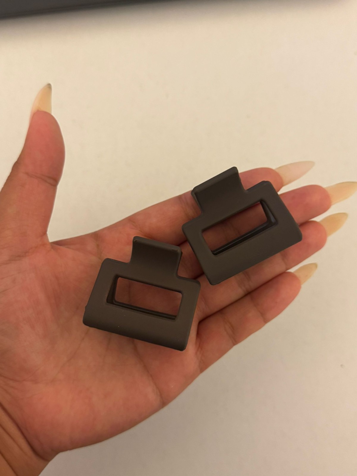Two beautiful, matte brown plastic hair clips, perfect for styling.