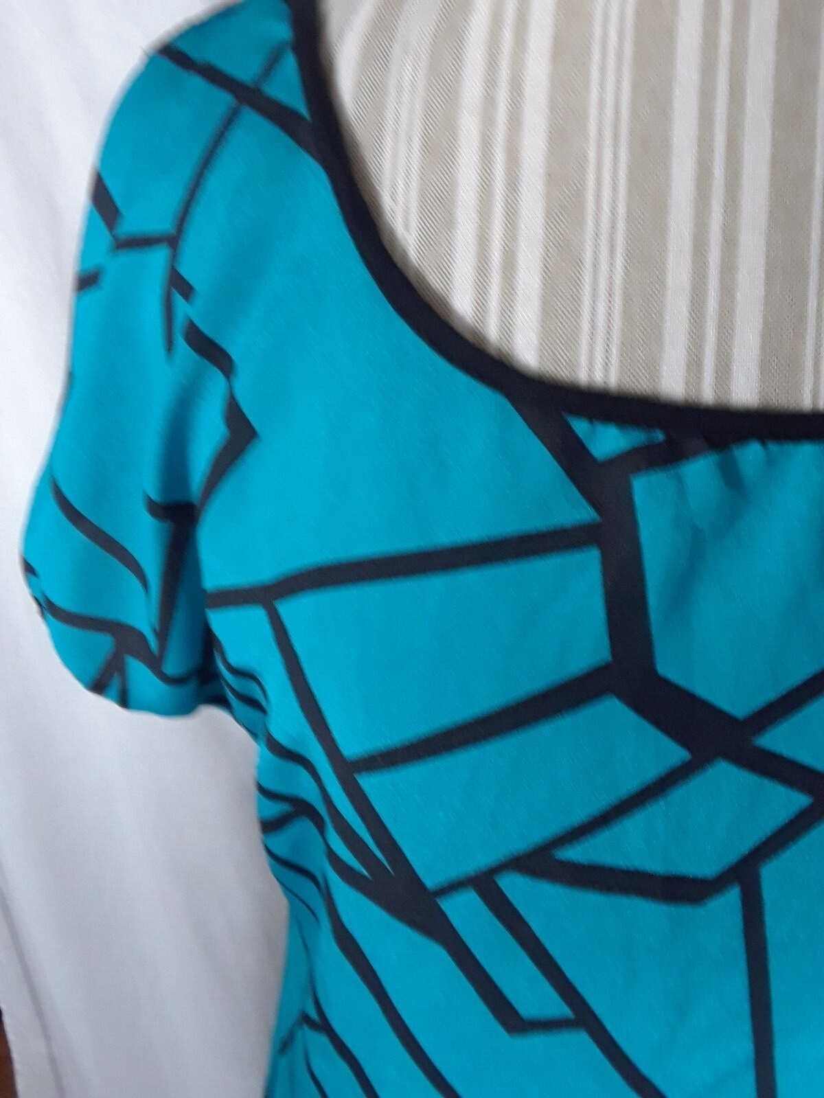 TA1-22 Espresso Women’s XL Blouse in black with blue geometric patterns in front