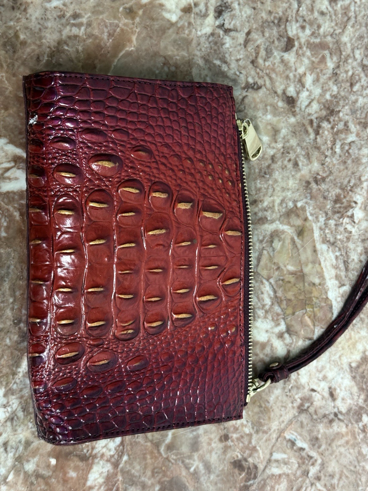 Brahmin Melbourne Daisy wristlet in an red and purple ombre crocodile leather