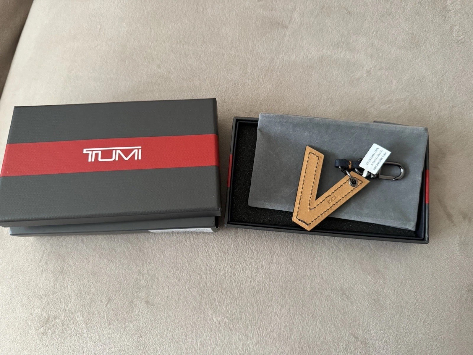 Tumi letter Charm “V”