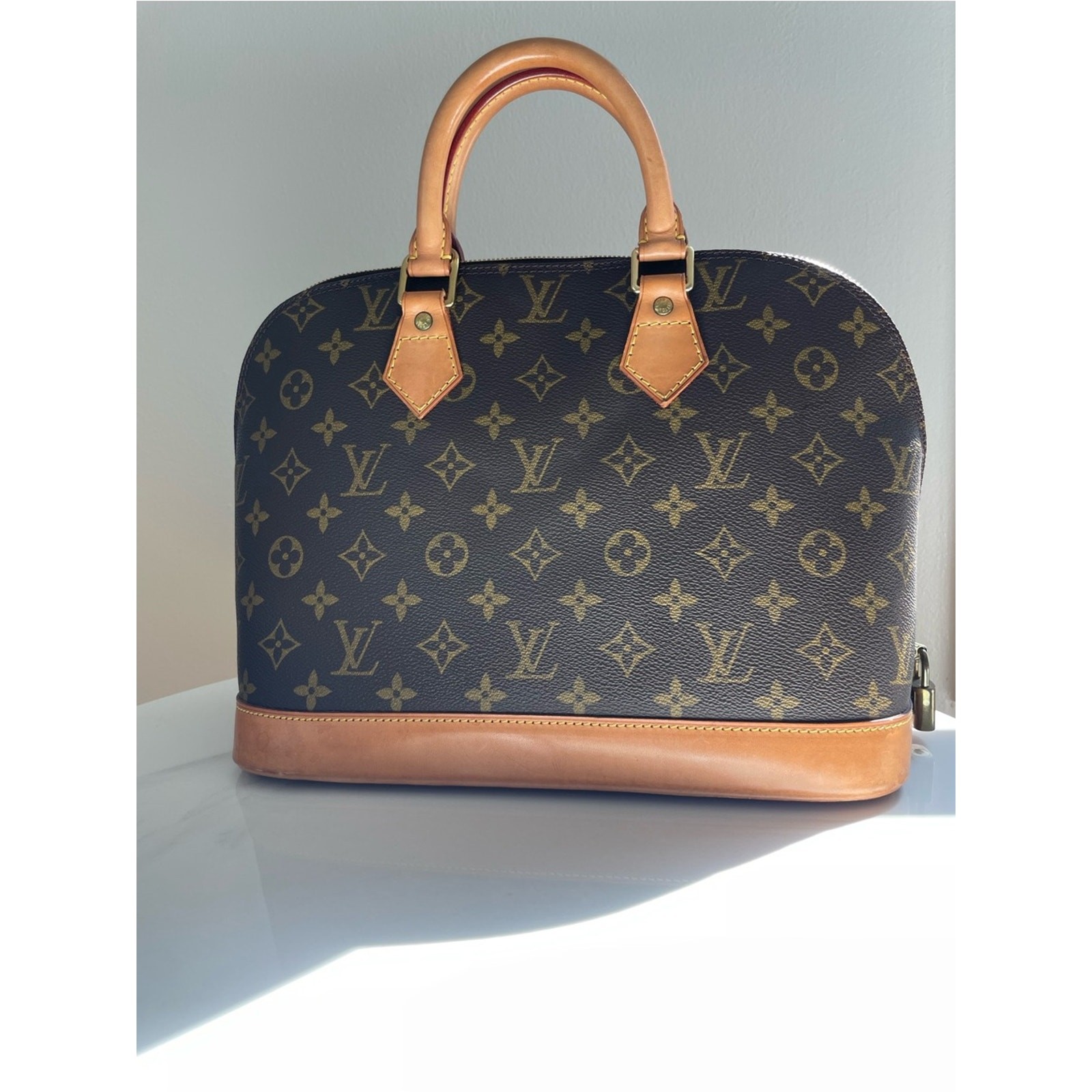 Authentic Louis Vuitton Alma PM handbag in classic Monogram canvas