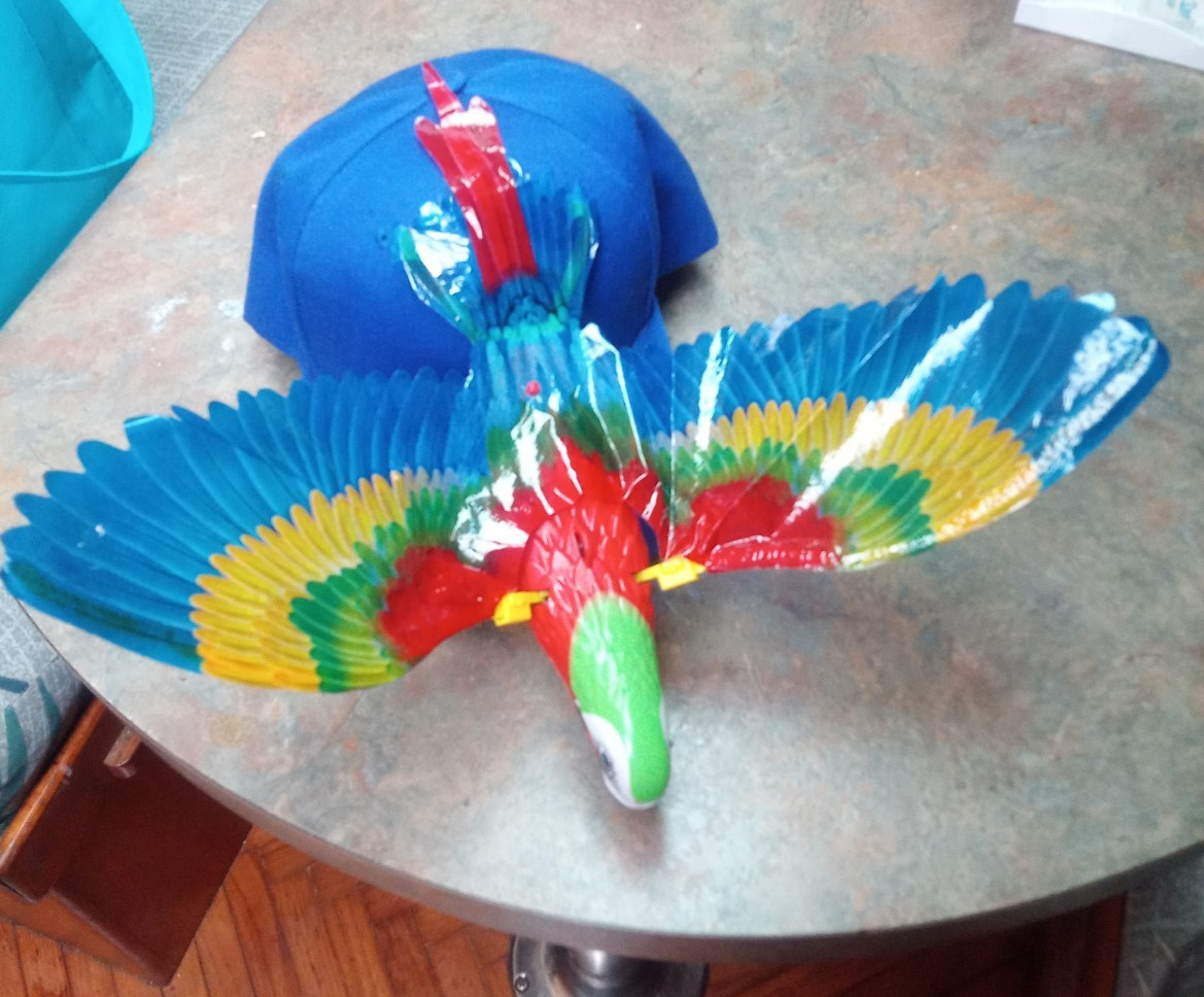 Parrot Head Hat 3D flapping wing bird with light up eyes & sound Jimmy