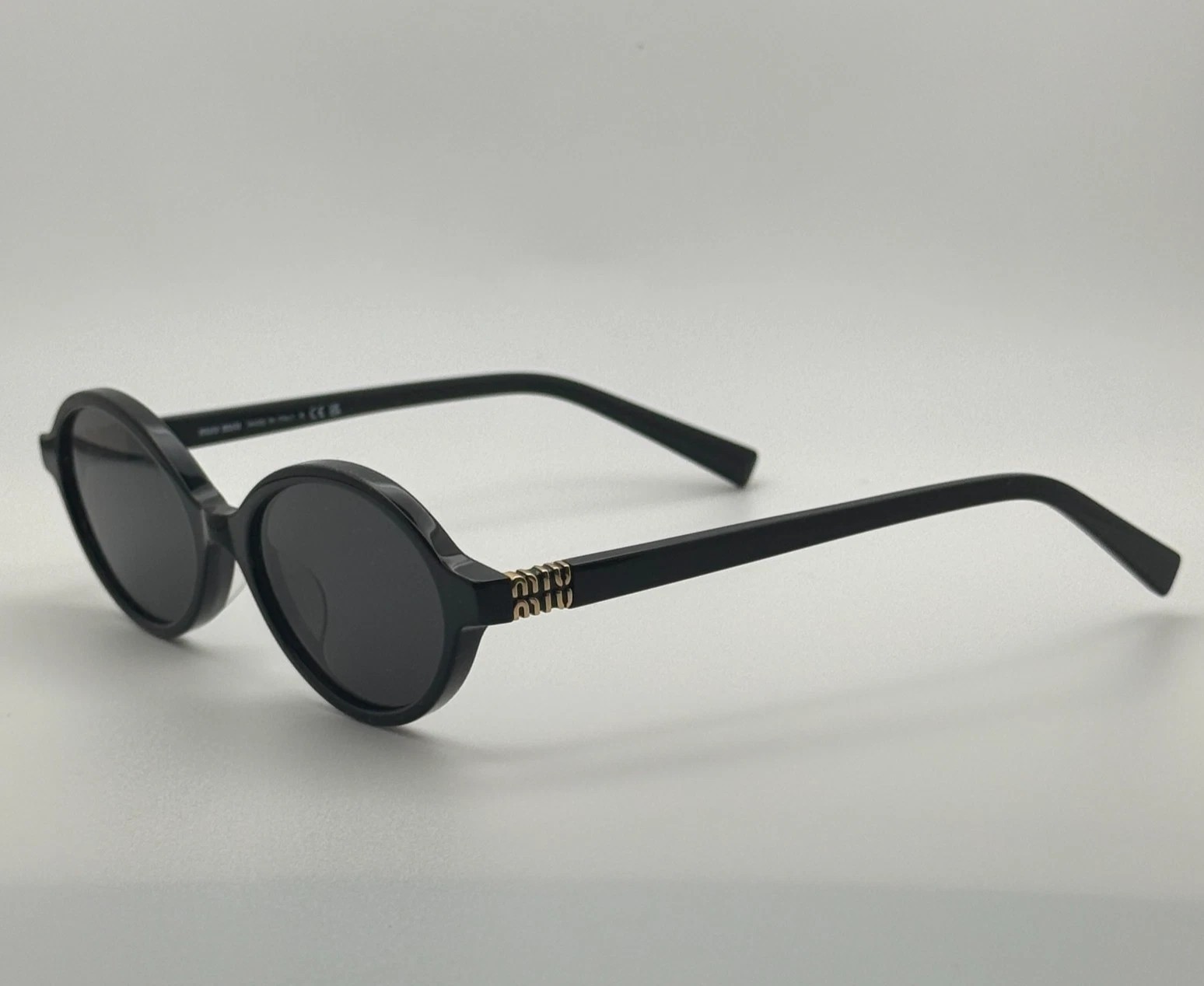 Miu Miu MU04ZS Round Oval Women’s Sunglasses Black Frame Dark Lenses