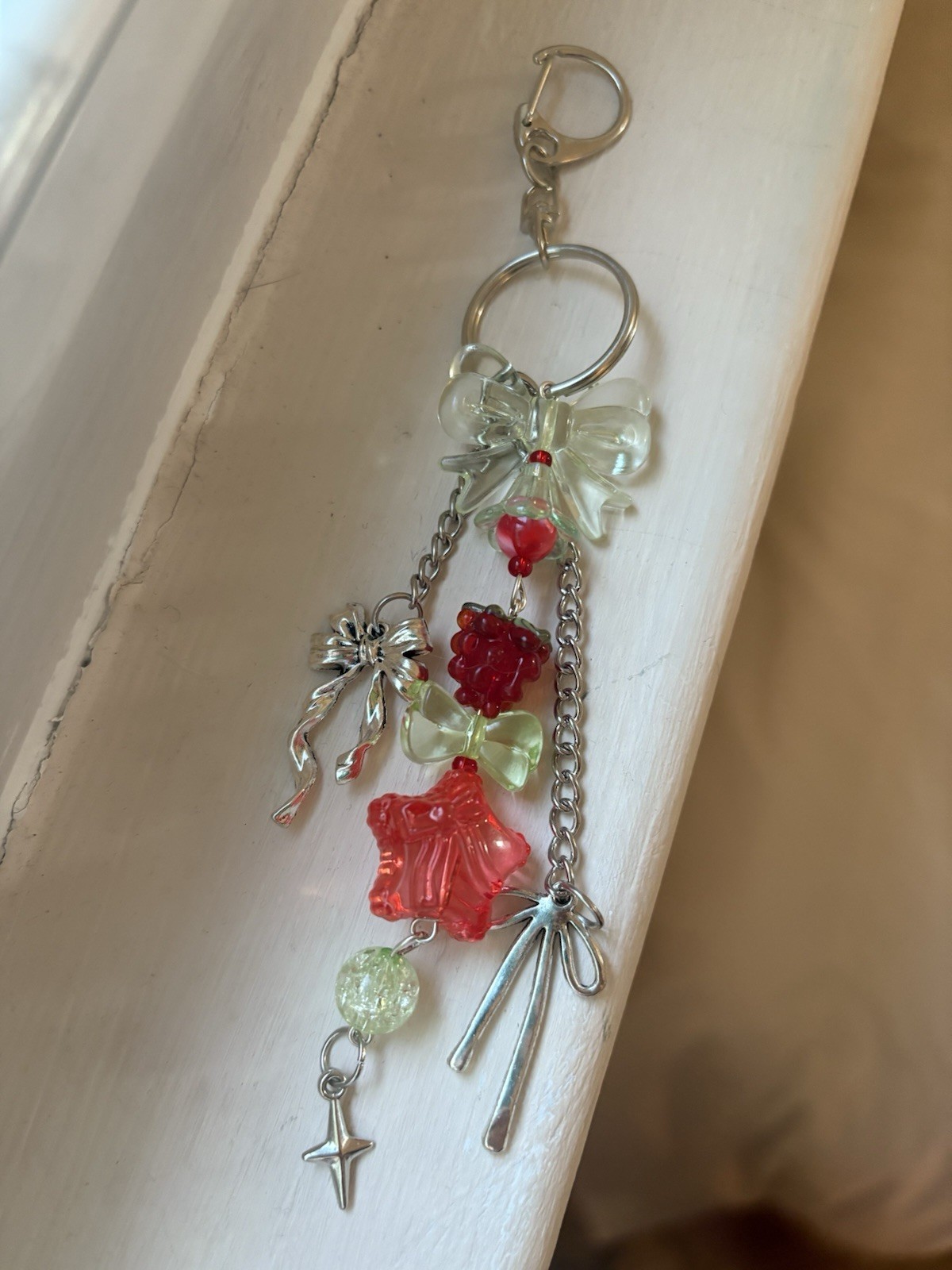 Handmade raspberry themed acrylic beaded with silver bow accented keychain