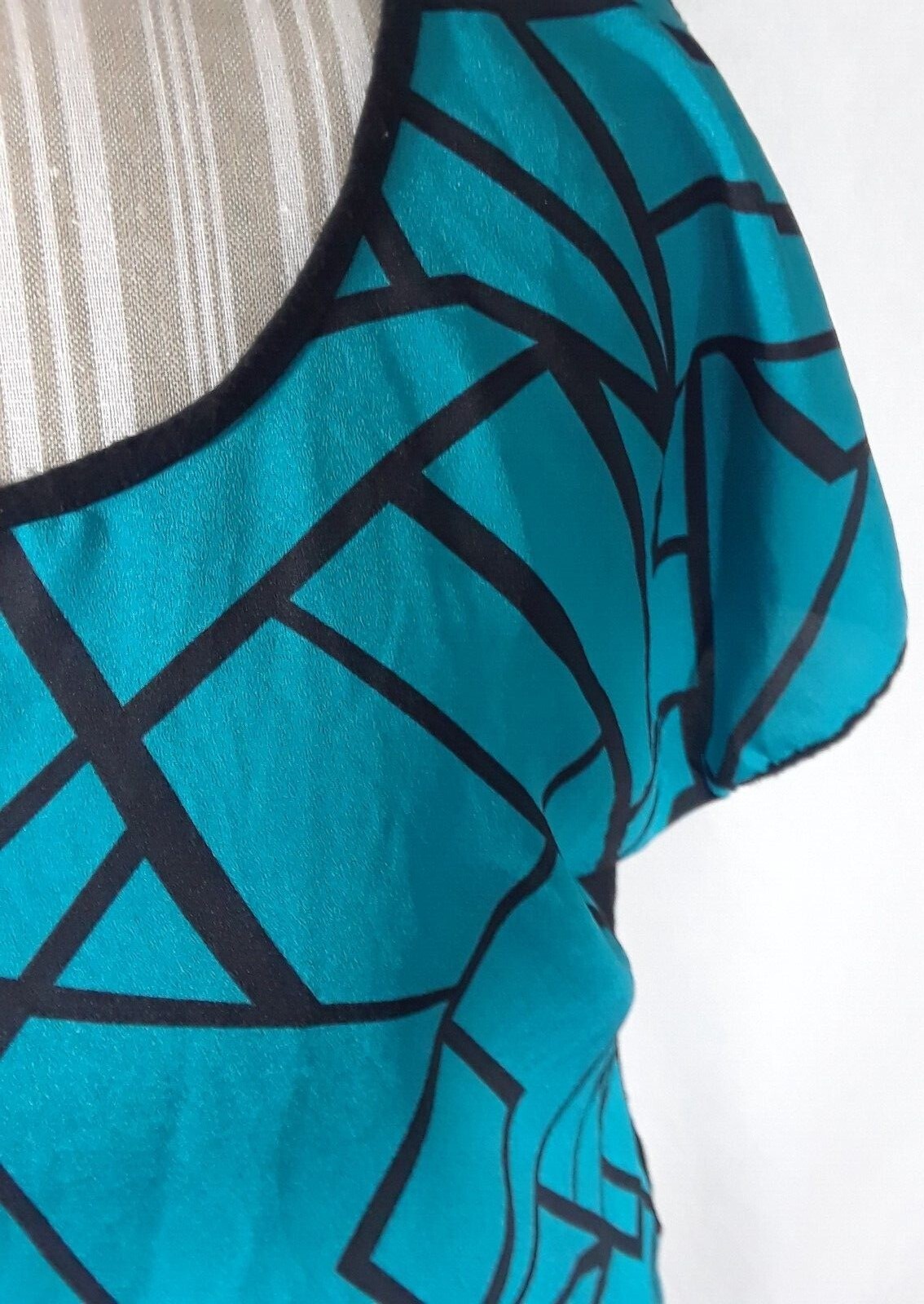 TA1-22 Espresso Women’s XL Blouse in black with blue geometric patterns in front